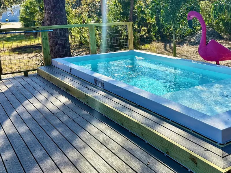 ReadyPool set into a raised composite deck on a sunny day, surrounded by trees